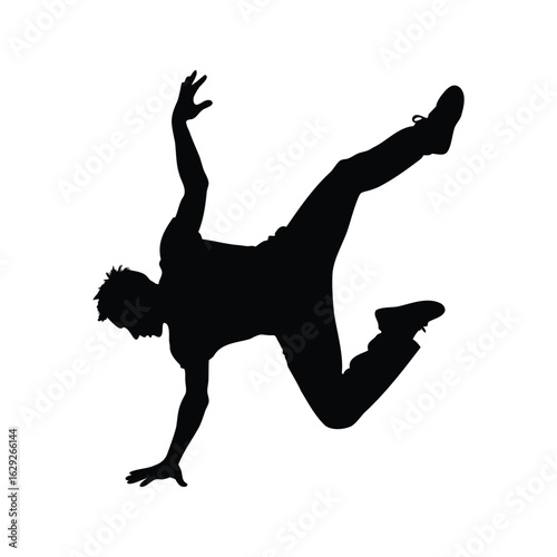 Silhouette of a skilled breakdancer performing a dynamic acrobatic move in midair