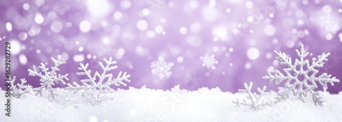 White snowflakes on a snowy landscape against a lavender bokeh background with falling snow