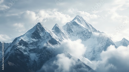 Majestic Snow-Capped Mountains Amidst Soft White Clouds
