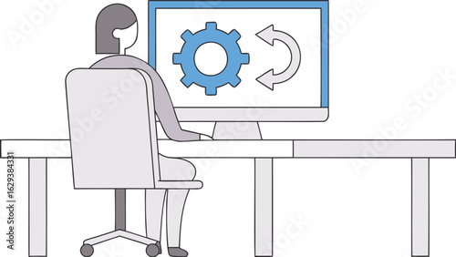 Person sitting at a desk in front of a computer monitor displaying a gear and looping arrows icon