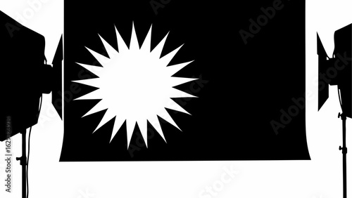 A black backdrop with a spiky white starburst and two studio lights on either side in silhouette