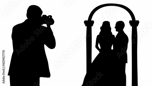 Silhouette of a photographer taking pictures of a couple under an archway in a black and white image