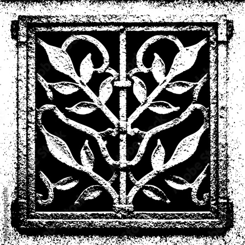 Ornate square metal grate with floral design and heavy texture in black and white artistic image