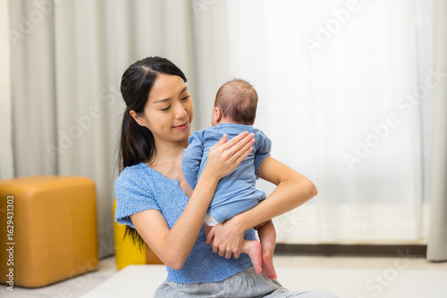 Photos Mother help baby to burp gently at home