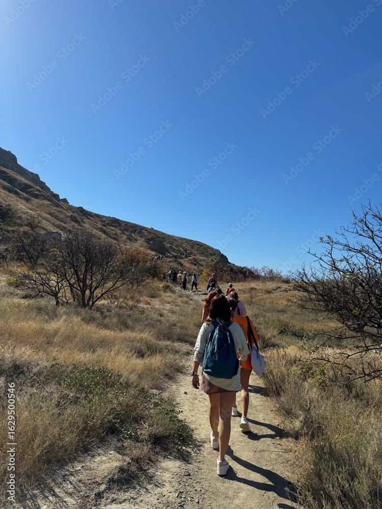 Naklejka premium A group of travelers climbing the mountains