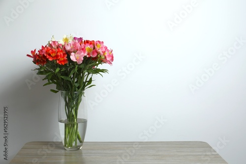 Wallpaper Mural Colorful alstroemeria flowers in glass vase on the table Torontodigital.ca