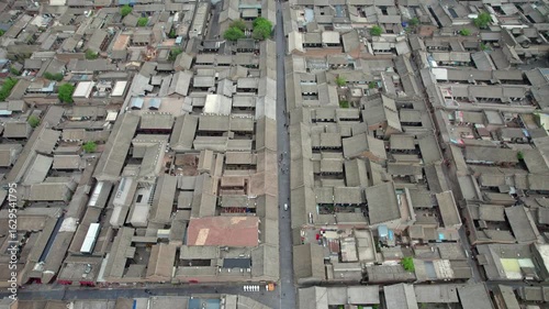 Drone view of Pingyao ancient city in Pingyao, Shanxi province, China. Aerial view of an old Asian town with traditional architecture and grey roofs, 4K real time Footage.