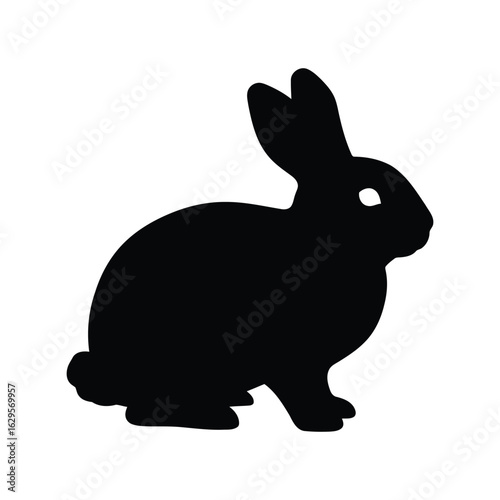 Black silhouette of a rabbit sitting and looking to the side isolated on white background