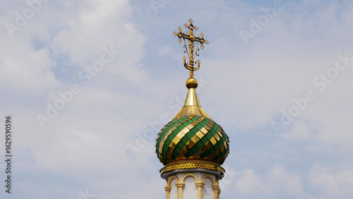 The dome of the Orthodox Church with a cross against the sky