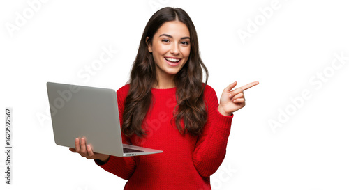 Smiling young woman in red sweater holding a laptop and pointing to the side isolated on transparent background