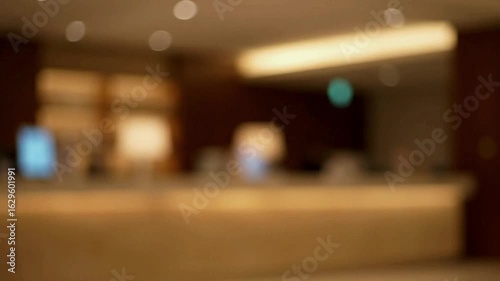 Wallpaper Mural Blurry hotel lobby with a reception desk lighting and a person looking at a phone Torontodigital.ca