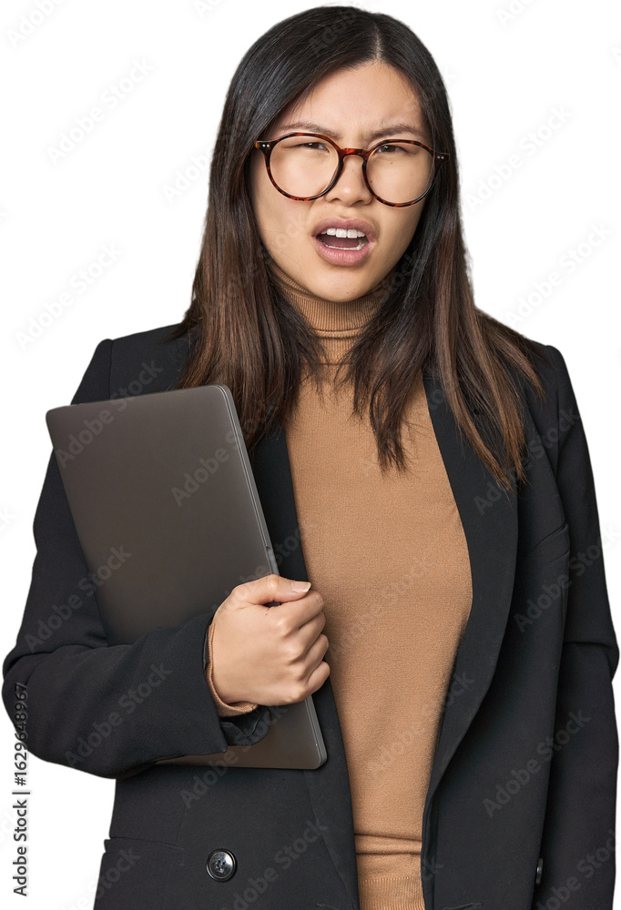 Young Chinese woman in business suit with laptop screaming very angry and aggressive. Young Chinese woman in business suit with laptop screaming very angry and aggressive.
