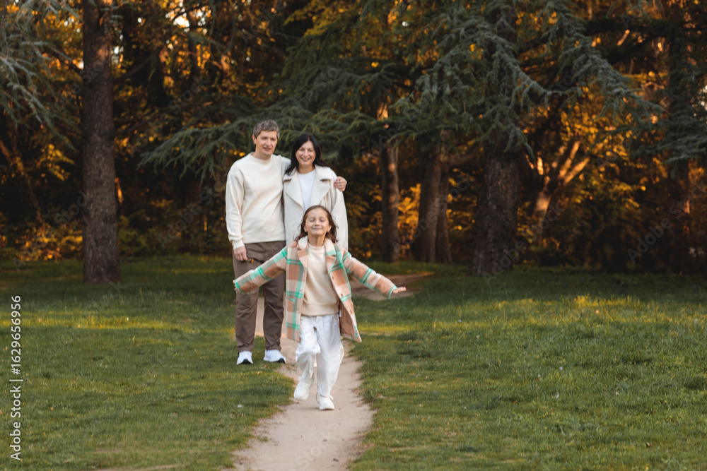 Fototapeta premium happy family walking in autumn park. autumn