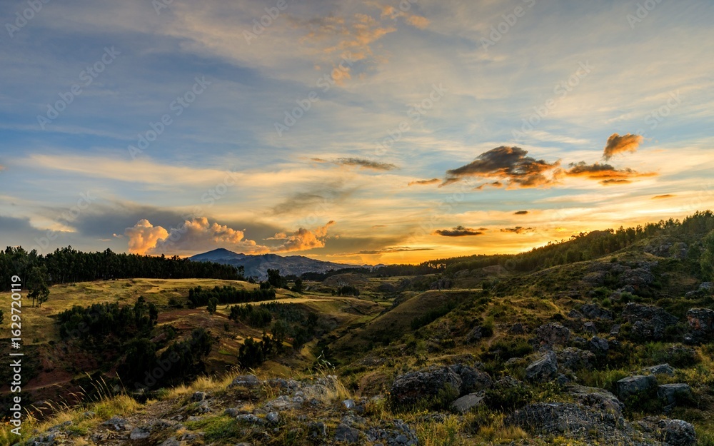 Fototapeta premium Stunning sunset over hilly landscape