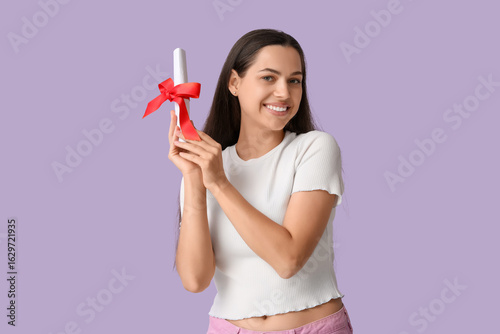 Happy young woman with dipl...