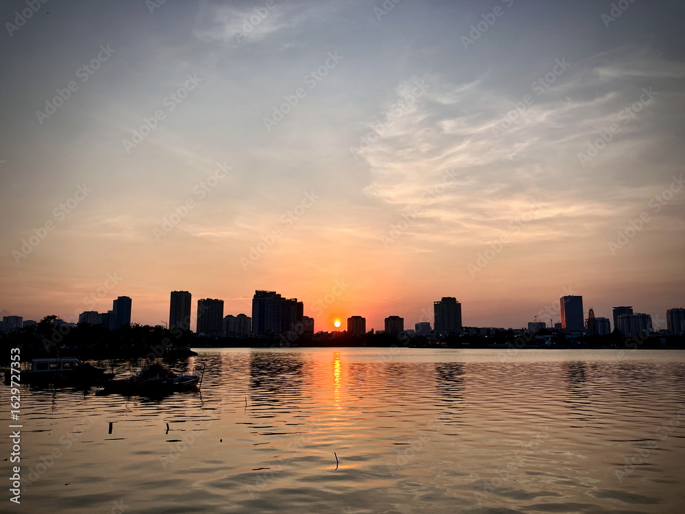 Fototapeta premium Fiery Evening Glow Above West Lake, Hanoi – Majestic Urban Sunset Panorama