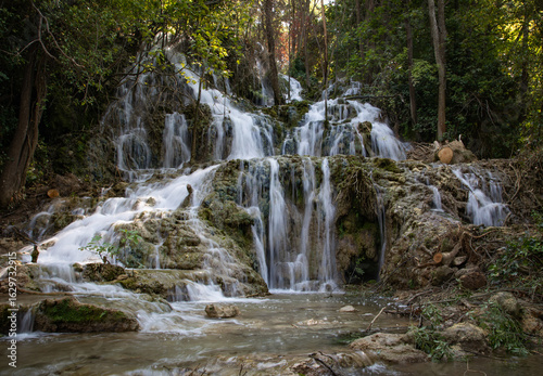  Peaceful waterfall in a Croatian national park surrounded by lush greenery and clear water. A stunning natural landscape ideal for travel, nature, adventure, and outdoor-themed content