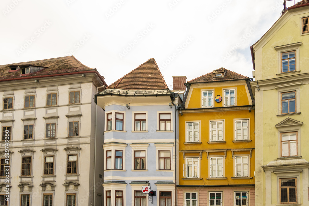 View of colorful buildings stand side by side, windows reflecting the soft light, creating a charming urban scene in Hauptplatz, Graz, Graz, Austria. View of colorful buildings stand side by side, windows reflecting the soft light, creating a charming urban scene in Hauptplatz, Graz, Graz, Austria.