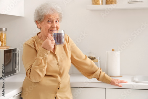 Smiling senior woman with g...
