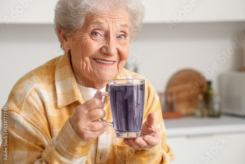 Happy senior woman with gla...