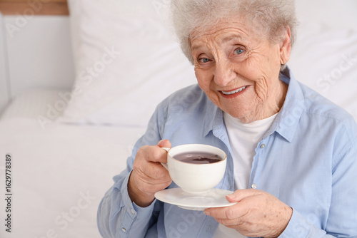 Smiling senior woman holdin...