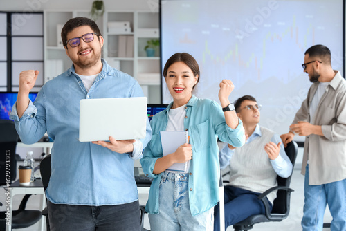 Happy traders with laptop i...