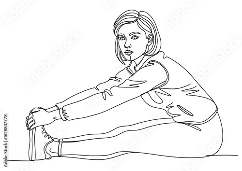 Woman seated on the floor, stretching her legs to touch her toes.