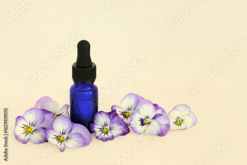 Ταπετσαρία Natural pansy flower homeopathic essence for alternative herbal medicine with blue bottle on hemp paper