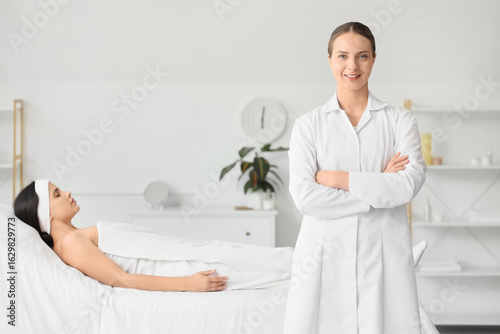 Female beautician against c...