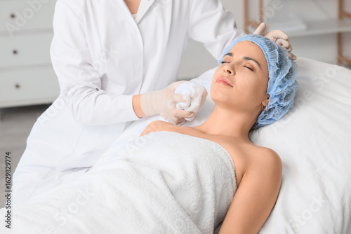 Beautician with towel and c...