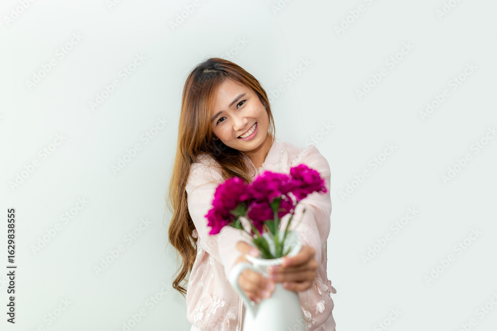 Pretty smiling asian woman wearing a dress is holding a bouquet of flowers isolated on white background. Pretty smiling asian woman wearing a dress is holding a bouquet of flowers isolated on white background.