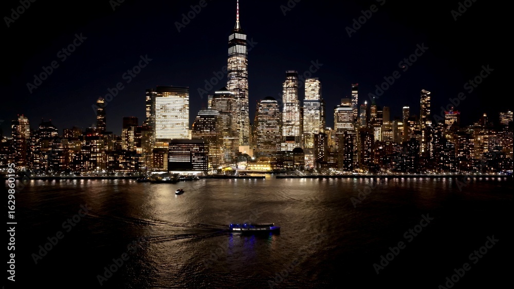 Obraz premium New York Skyline In Manhattan New York United States. Aerial View Of A Bustling City With High-Rise Buildings And Traffic. Night Freeway Road Downtown Cityscape. Night Up Above.