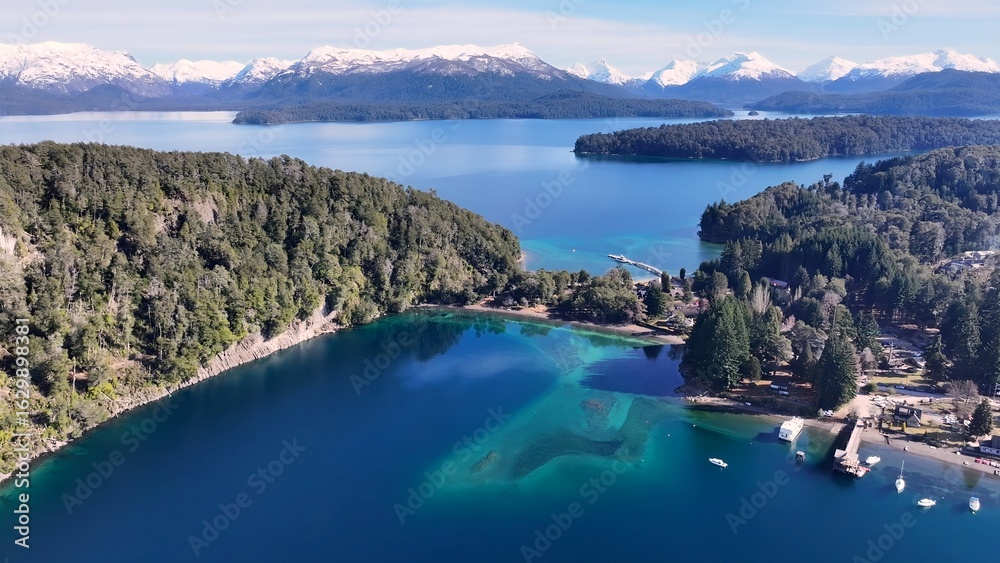 Fototapeta premium Patagonia Skyline In Villa La Angostura Neuquen Argentina. Bird Eye View Of A Amazing Coastal Beach In The Summer Holiday. Nature Travel Destinations Snow Covered Forest Trees.