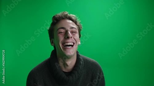 portrait of a young man smilling so much green screen 
