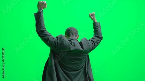 young man with arms raised like he win somthing 