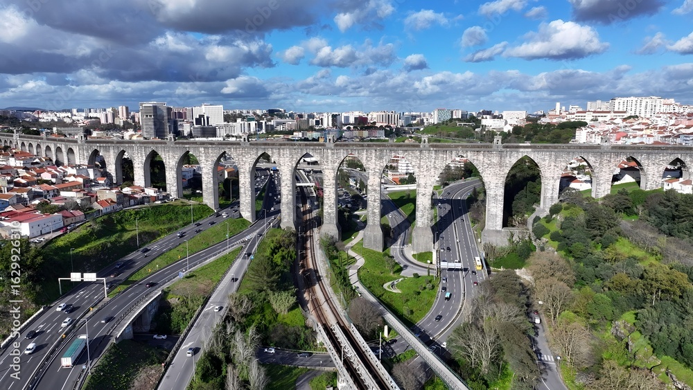 Obraz premium Aguas Livres Aqueduct In Lisbon Portugal. Aerial View Of Landmark Medieval Building In Downtown Scene. Industrial Landscape Buildings Stunning. Urban Buildings Town. Lisbon Portugal.