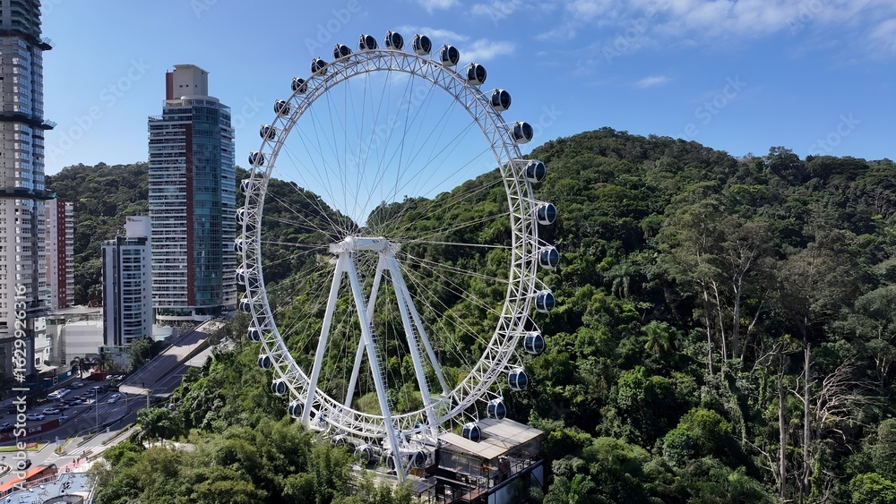 Obraz premium Famous Ferris Wheel In Balneario Camboriu Santa Catarina Brazil. Ferris Wheel Shining Over Downtown District Landscape. Industrial Skyline Skyscrapers Amazing. Industrial Cityscape.