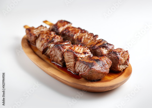 Delicious beef skewers, grilled, wood plate or tray. Isolated white background, Brazilian traditional 