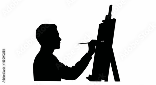 Silhouette of an artist painting on a canvas with an easel in a studio creating art with a brush stroke