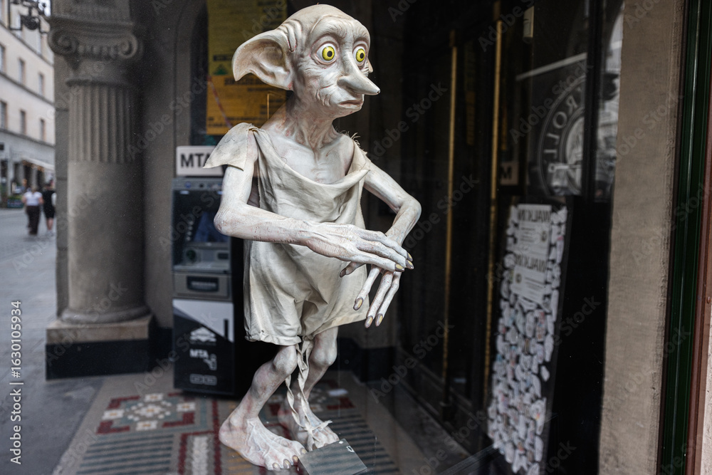 Fototapeta premium Statue of Dobby from Harry Potter mythical creature displayed in Krakow, Poland city street view