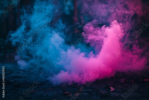 Vibrant pink and blue smoke billows dramatically creating an ethereal and mystical atmosphere against a dark background