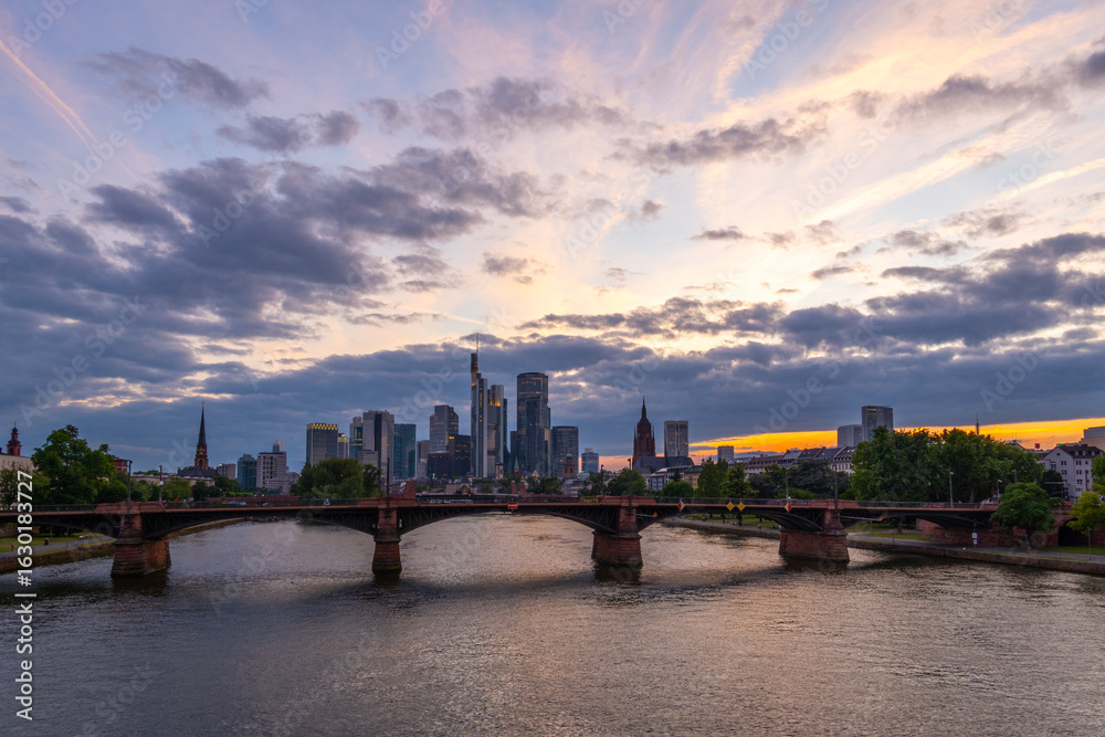 Fototapeta premium Illuminated Frankfurt City Downtown, Ignatz Bubis Bridge and Main River at Summer Sunset. Hesse, Germany