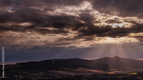 sun rays and clouds over the mountains