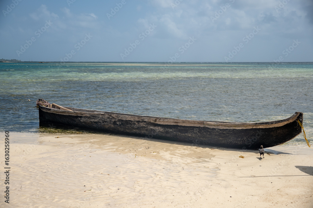 Fototapeta premium Wooden boat pulled up on the beach on an island in the San Blas Islands, Panama