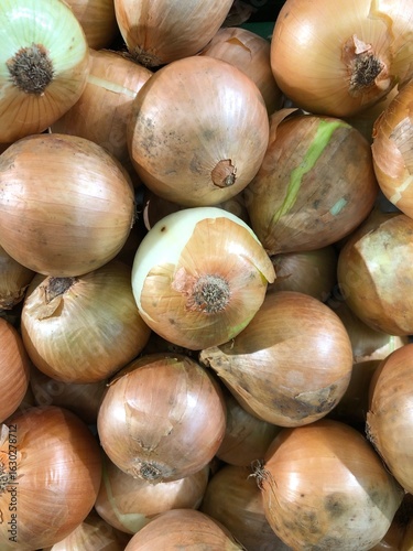 Fresh red and yellow onions, healthy and natural vegetables, are sold at a market, ready to be used as an ingredient in cooking