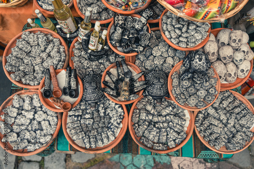 Obraz na plátně Clay bowls filled with handmade skull figurines, ritual objects and traditional