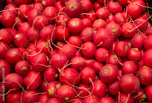 Close-up of lying fresh red radish in supermarket boxes.