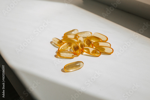Omega-3 in sunlight. Natural fish oil for hair growth. The concept of vitamins and dietary supplements