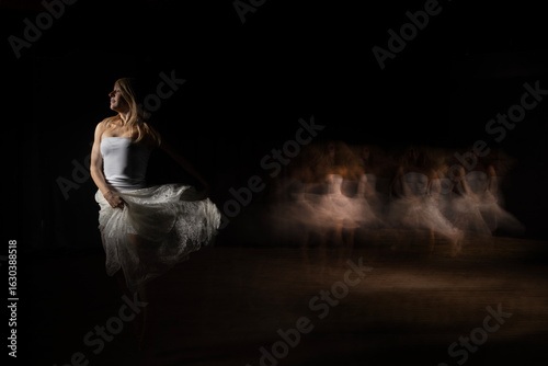 This image captures a woman in motion, seemingly dancing or twirling with a piece of white fabric 