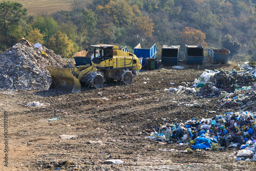 A compactor at a landfill processes sorted waste into containers